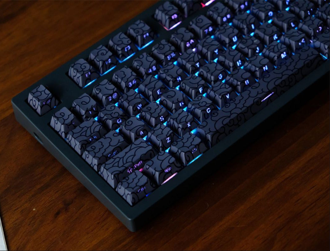 Mechanical keyboard with Black Ink Swirl Side Engraved Cherry Keycaps on a wooden surface